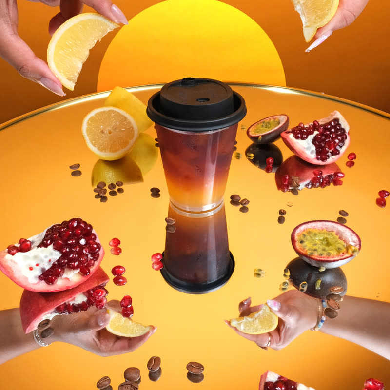 A layered Charged Lemonade with fresh citrus and pomegranate